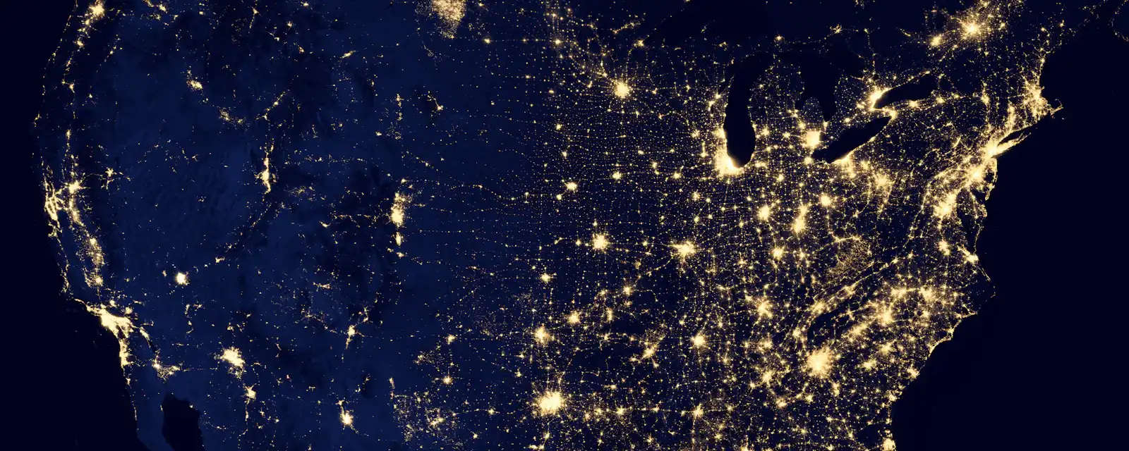Aerial view of a city at night representing internet-facing exposure