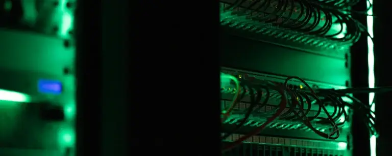 Server rack in a dark room, scanned regularly for vulnerabilities