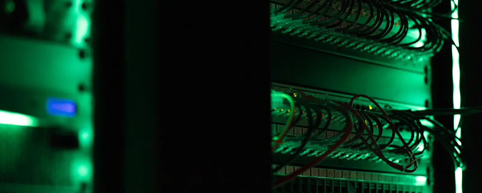 Server rack in a dark room, scanned regularly for vulnerabilities